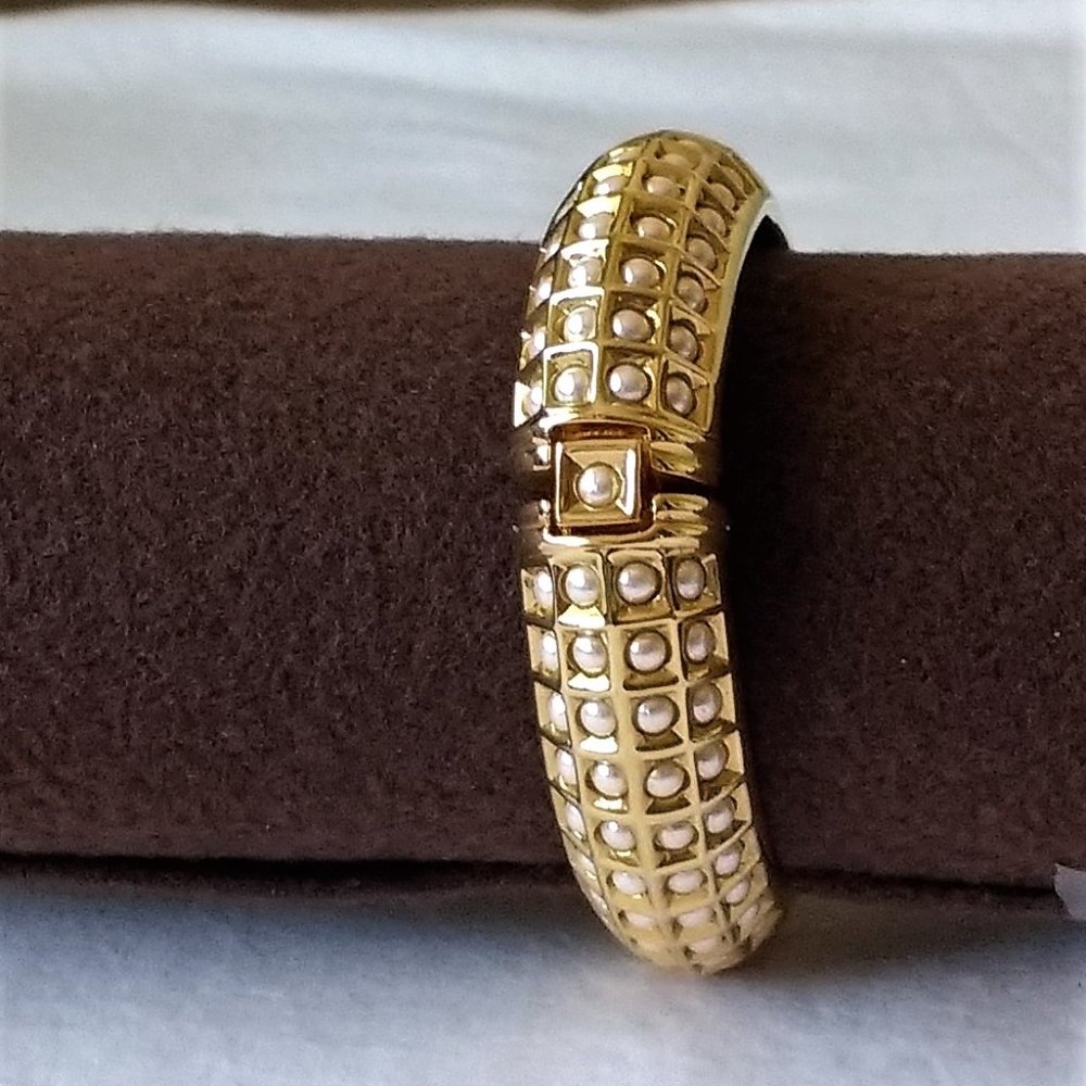Gold toned with embedded pearls bracelet.
